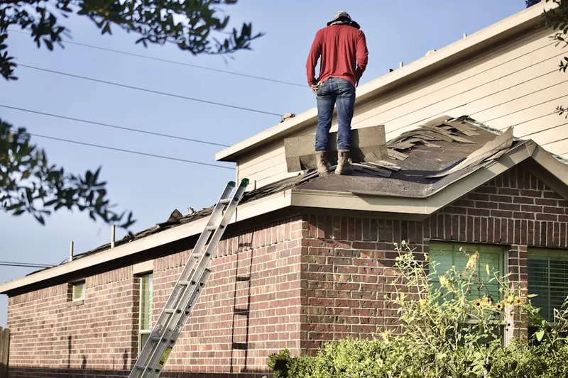 Professional roofer working on a residential roof in Rhinelander